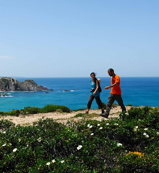 Couple hiking along Costa Vicentina coastline